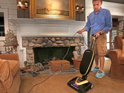 man cleaning carpet